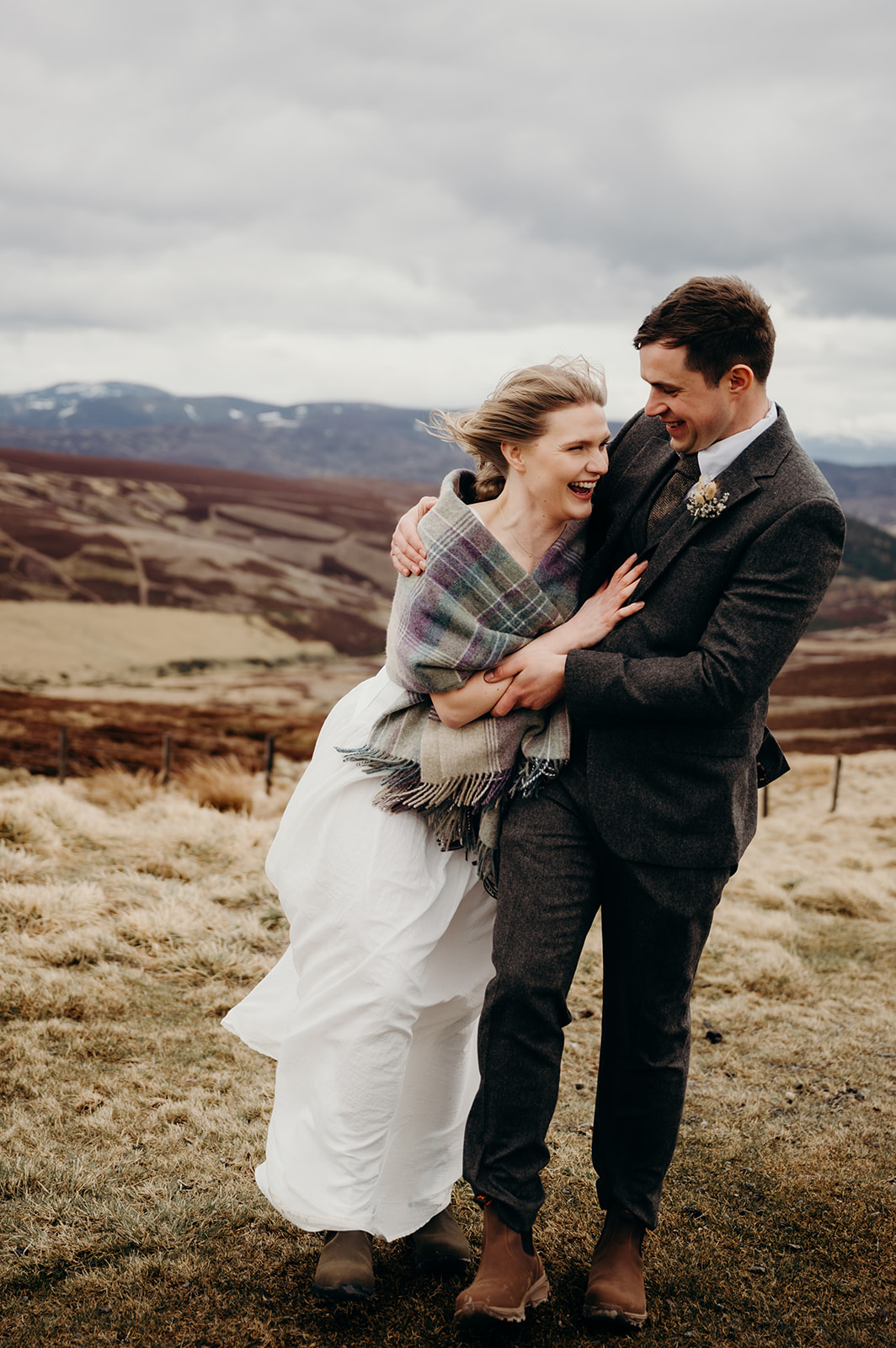 A couple eloping in the Scottish hills